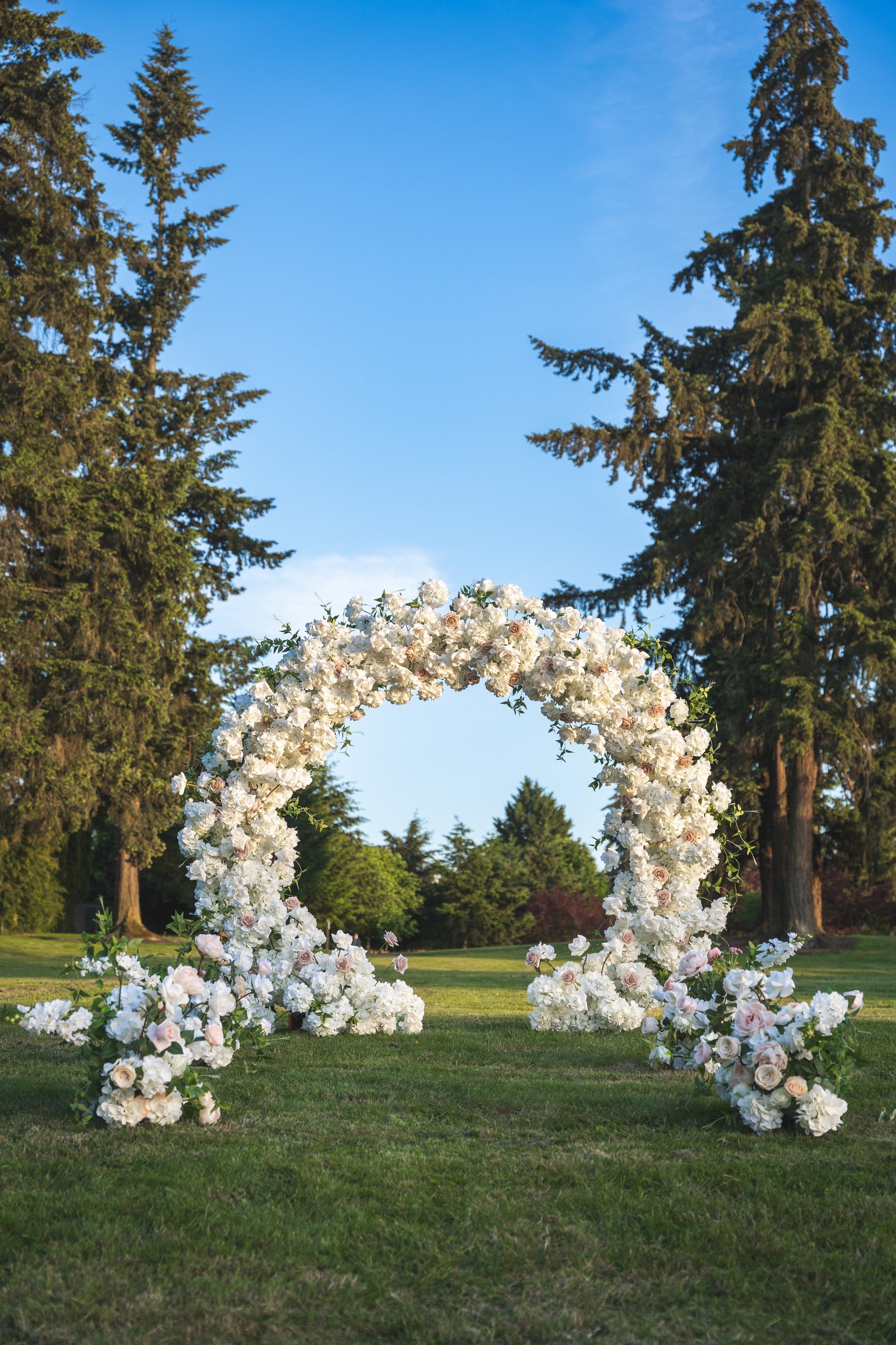 Everlasting Arch Designs garden wedding featuring circle arch rental and aisle flowers
